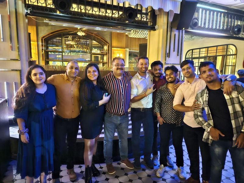 A group of colleagues posing at an evening event