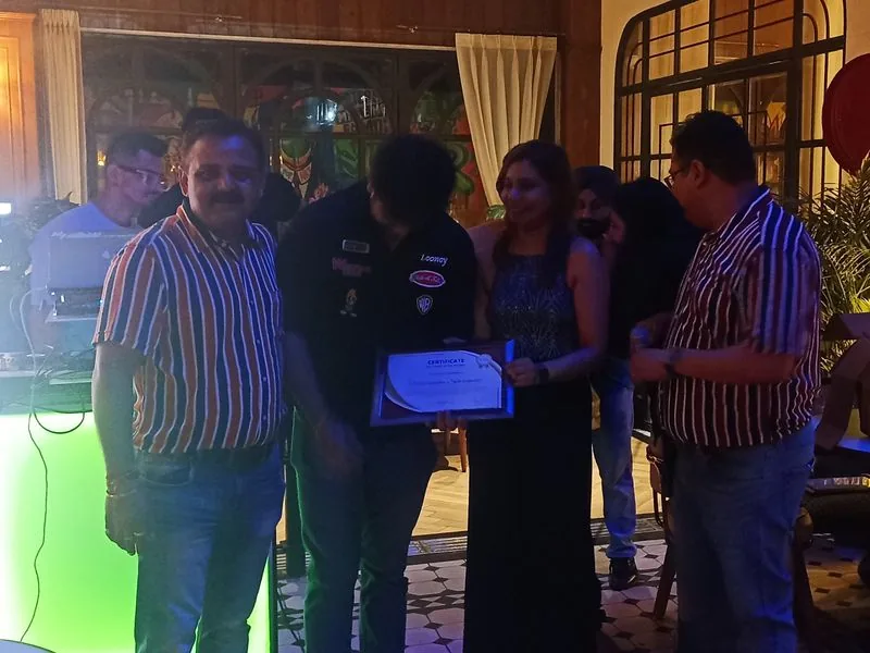 Colleagues with an award certificate at a team event