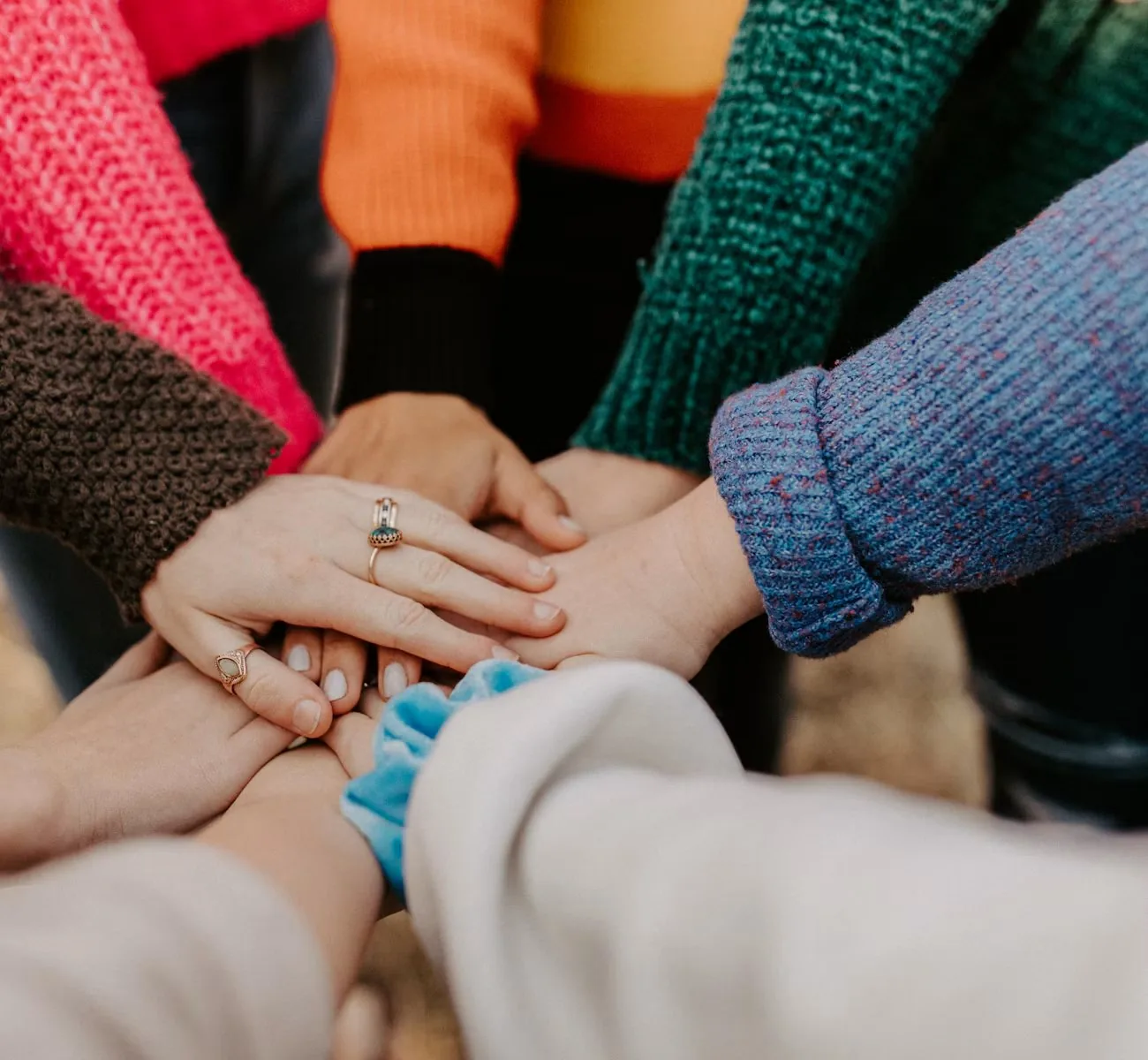 Colleagues joining hands in a circle