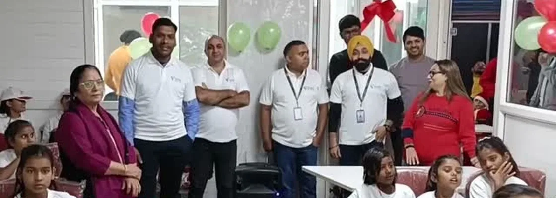 VMS team members with children at a foundation celebration in Dwarka