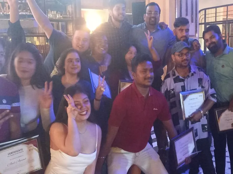 Colleagues posing together, holding certificates