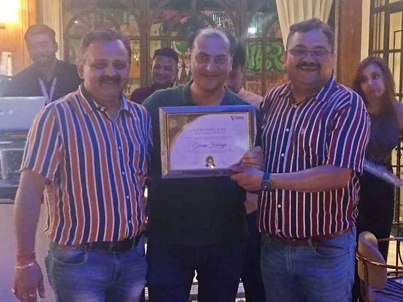 Leaders presenting a framed award to a colleague