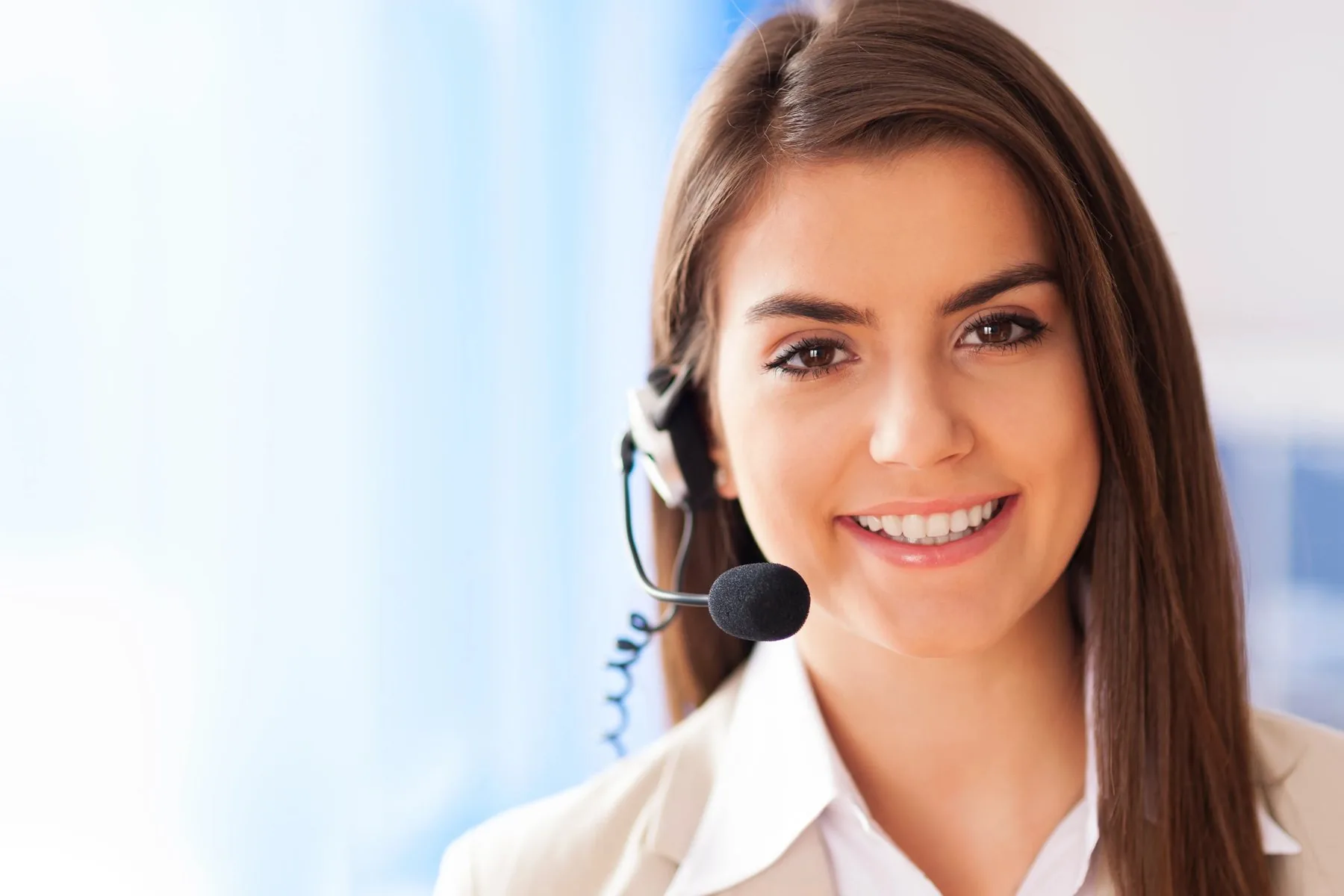 A smiling VMS support specialist wearing a headset, ready to help