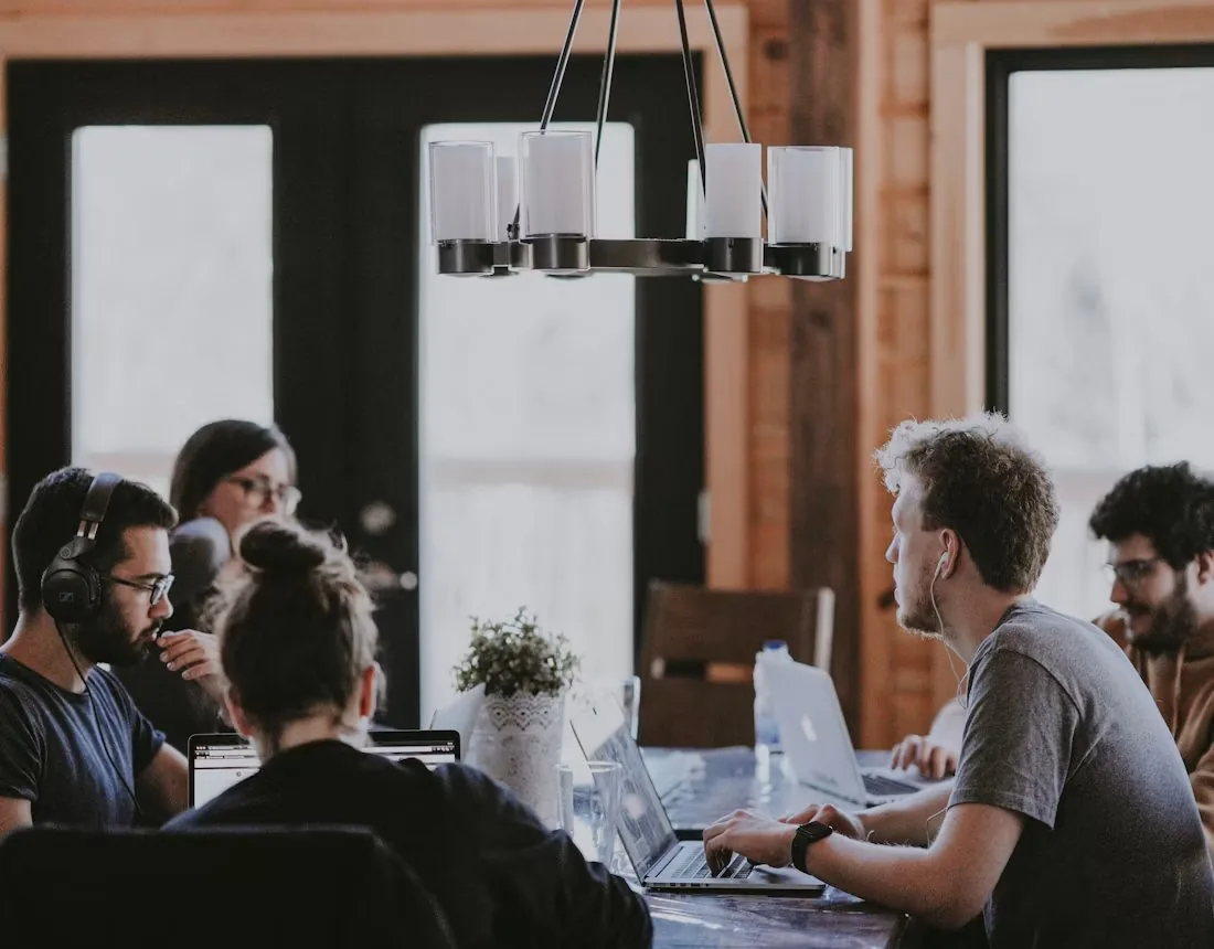 A team working together on laptops around a table